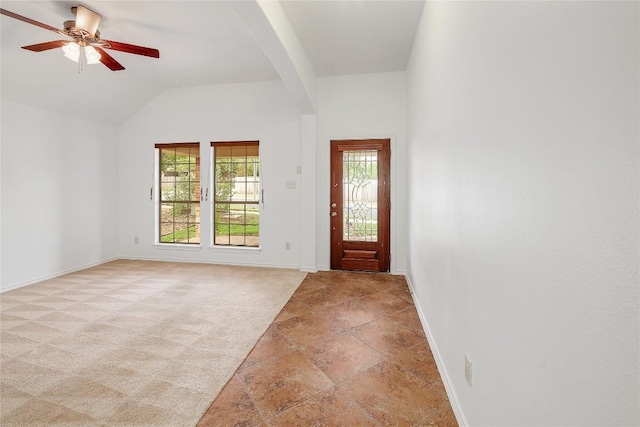 entryway with arched walkways, baseboards, a ceiling fan, and light carpet