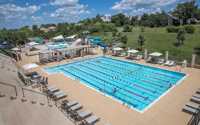 15 Borello Dr, Austin, TX 78738 - community pool featuring a patio and view of wooded area