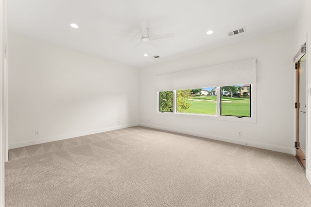 empty room with ceiling fan, light colored carpet, visible vents, baseboards, and recessed lighting