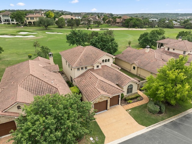 birds eye view of property with golf course view and a residential view