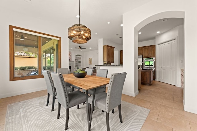 15 Borello Dr, Austin, TX 78738 - dining area with ceiling fan, arched walkways, light tile patterned flooring, recessed lighting, and a chandelier