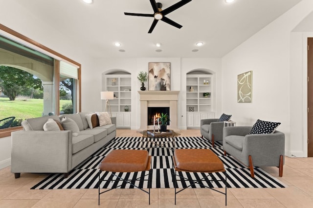 15 Borello Dr, Austin, TX 78738 - tiled living area with ceiling fan, built in features, a warm lit fireplace, and recessed lighting