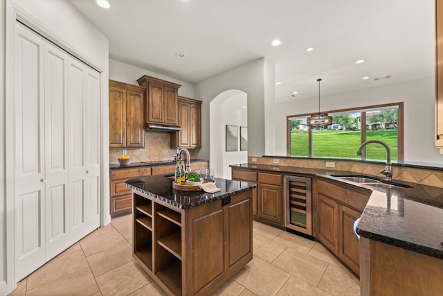 15 Borello Dr, Austin, TX 78738 - kitchen with wine cooler, backsplash, dark stone counters, open shelves, and recessed lighting
