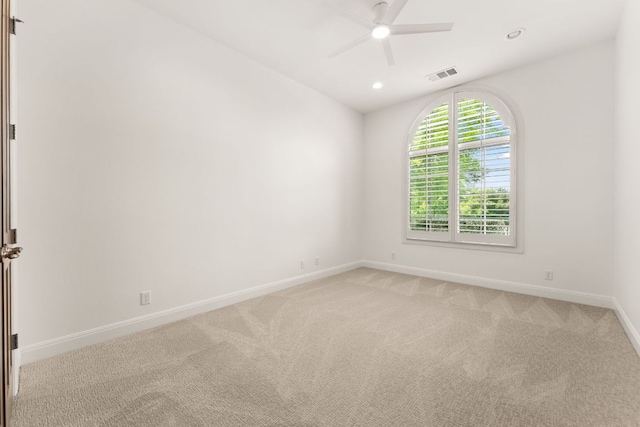unfurnished room featuring a ceiling fan, baseboards, visible vents, and light colored carpet