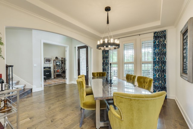 4101 Front Range Ln, Austin, TX 78732 - dining area featuring an inviting chandelier, baseboards, a raised ceiling, arched walkways, and dark wood finished floors