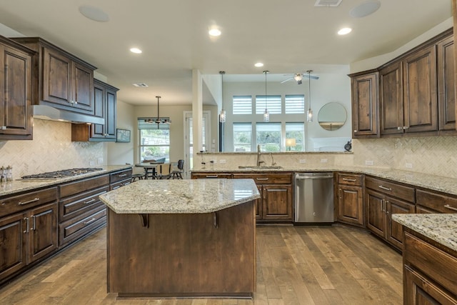 4101 Front Range Ln, Austin, TX 78732 - kitchen featuring ceiling fan, a sink, a center island, stainless steel appliances, and under cabinet range hood