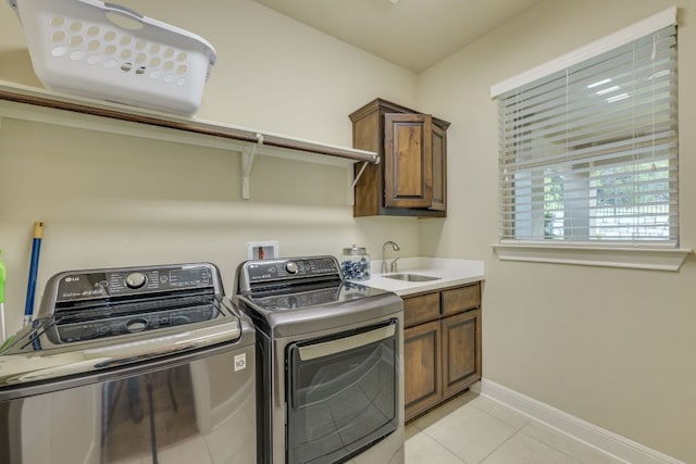 4101 Front Range Ln, Austin, TX 78732 - laundry room with washing machine and dryer, cabinet space, a sink, light tile patterned floors, and baseboards
