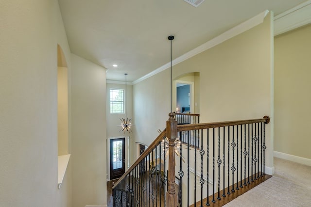4101 Front Range Ln, Austin, TX 78732 - stairs featuring crown molding, arched walkways, baseboards, and carpet floors