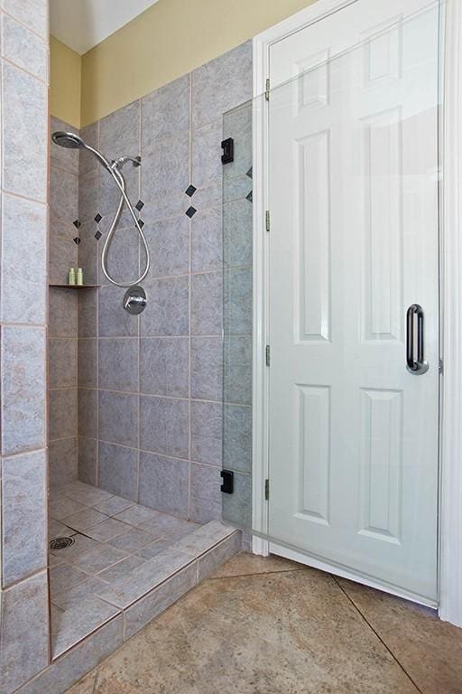 bathroom featuring a shower stall and tile patterned flooring
