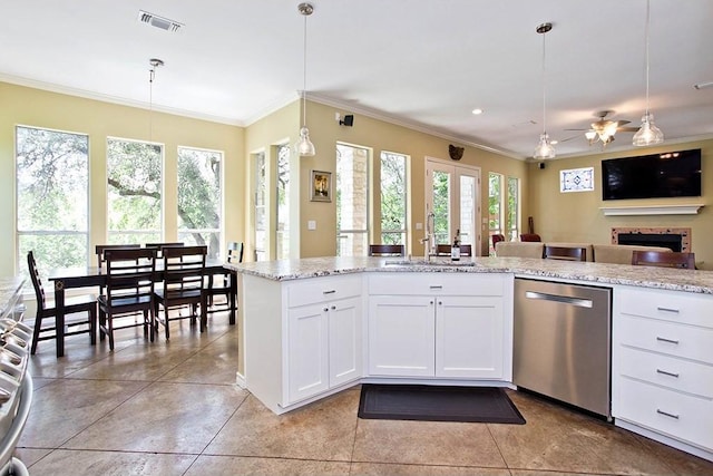 kitchen with a sink, visible vents, ornamental molding, and dishwasher