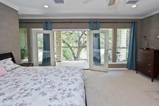 carpeted bedroom with crown molding, a ceiling fan, visible vents, and french doors