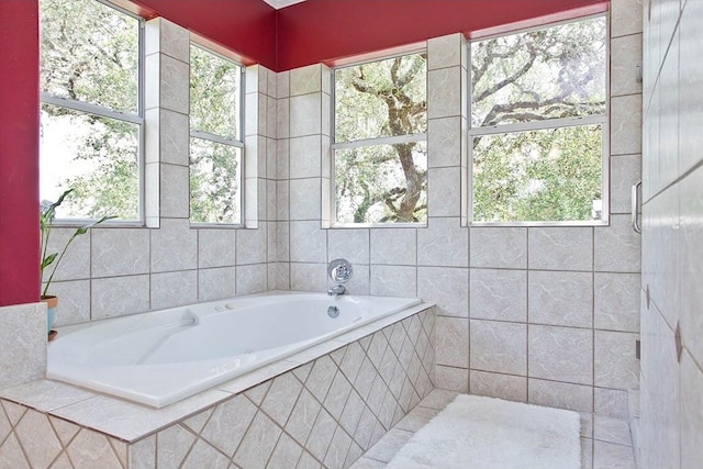 full bath featuring a garden tub and tile walls