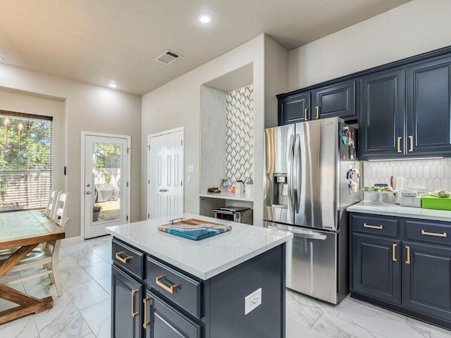 kitchen with stainless steel refrigerator with ice dispenser, marble finish floor, backsplash, and visible vents