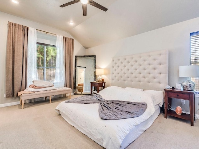carpeted bedroom featuring a ceiling fan, multiple windows, and lofted ceiling