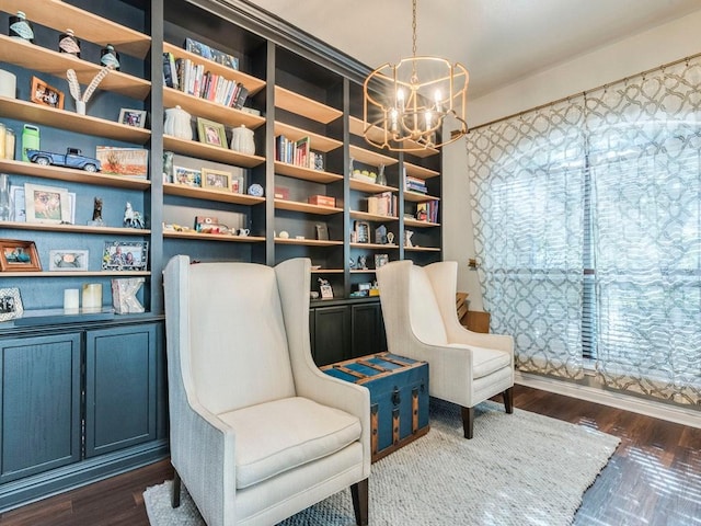living area featuring an inviting chandelier and dark wood-type flooring