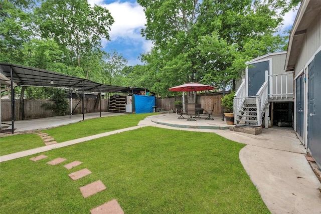 view of yard featuring a fenced backyard, stairs, and a patio