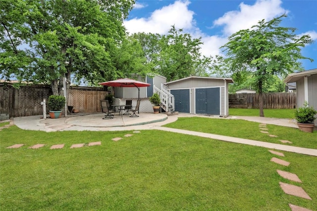 view of yard featuring an outdoor structure, a patio, a shed, and a fenced backyard