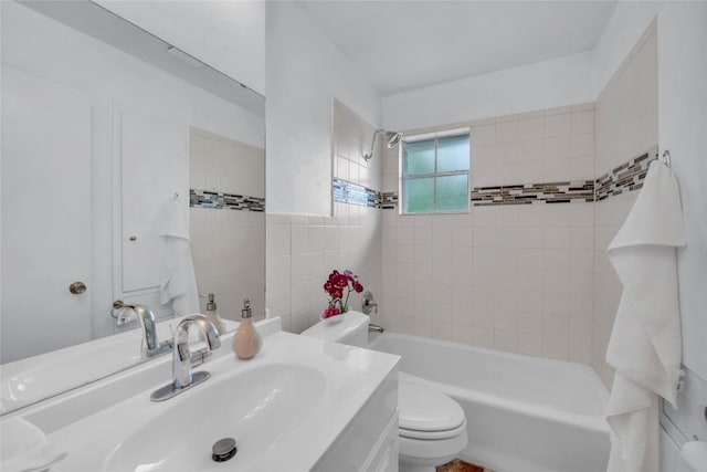 bathroom with shower / bathtub combination, toilet, tile walls, and vanity