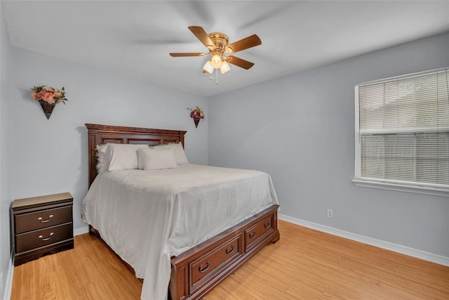 bedroom with baseboards, ceiling fan, and light wood finished floors