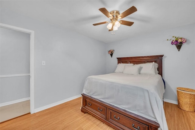 bedroom featuring baseboards, light wood-style flooring, and ceiling fan