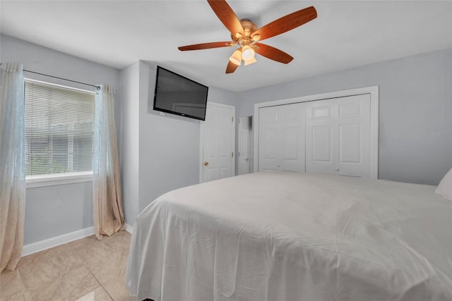 bedroom with baseboards, ceiling fan, and a closet