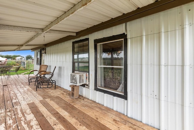 wooden terrace featuring a porch and cooling unit
