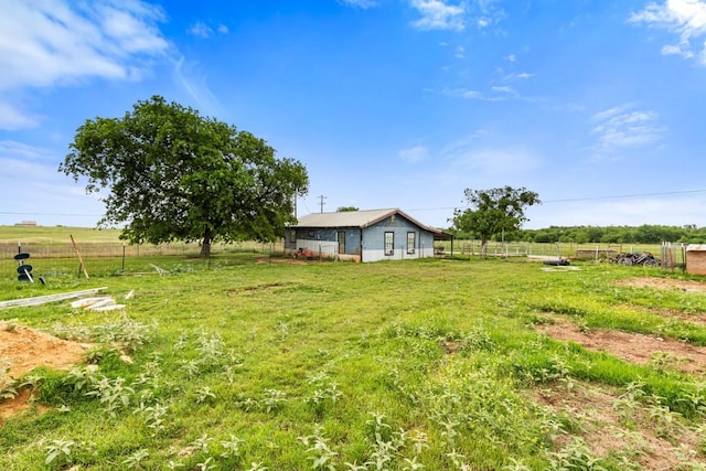view of yard featuring fence and a rural view