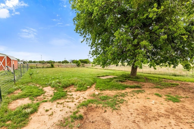 view of yard with a rural view and fence