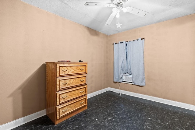 unfurnished bedroom with baseboards, ceiling fan, and cooling unit