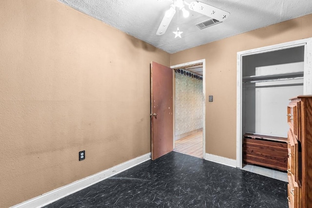 unfurnished bedroom featuring visible vents, a textured ceiling, baseboards, and tile patterned floors