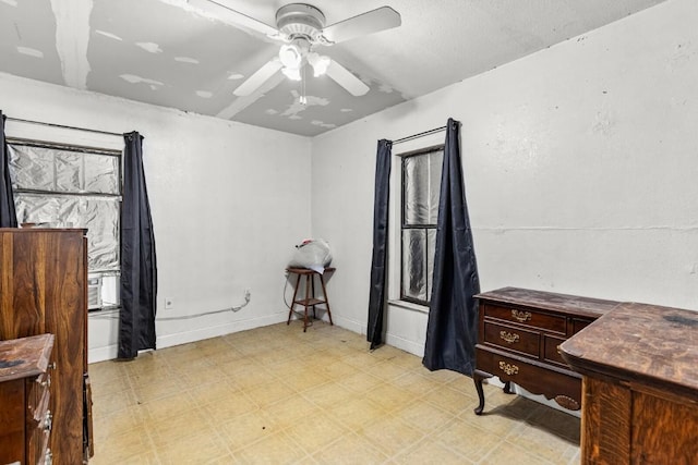 bedroom featuring a ceiling fan, baseboards, and light floors