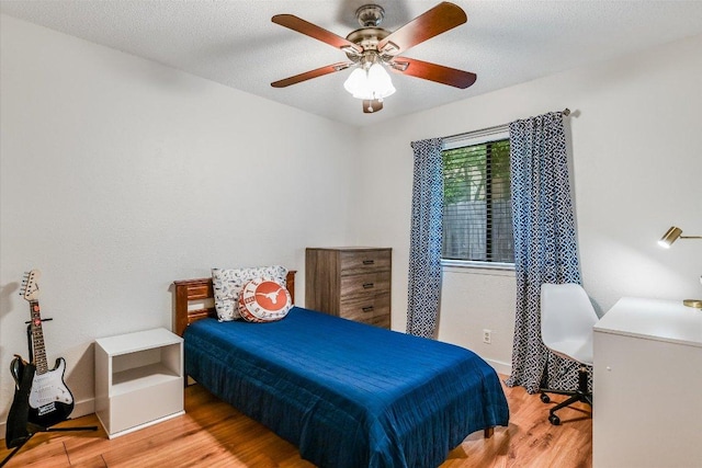 bedroom with ceiling fan and wood finished floors