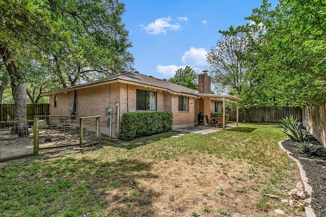 2604 Fentonridge Dr, Austin, TX 78745 - back of property with a chimney, brick siding, and a patio