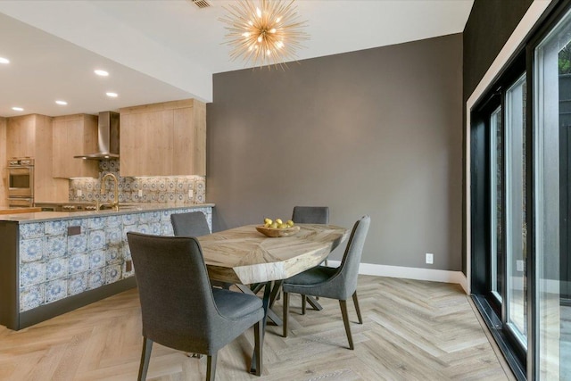 dining area with baseboards, recessed lighting, and a chandelier