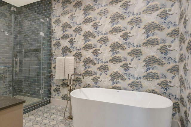 full bath featuring baseboards, a soaking tub, and a stall shower
