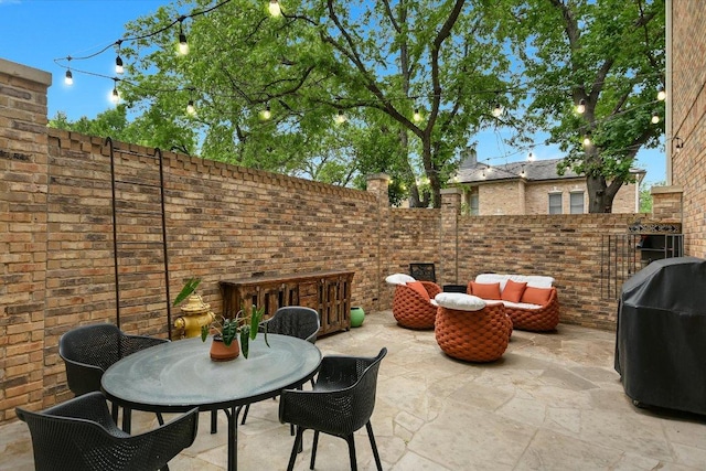 view of patio / terrace with a fenced backyard, outdoor dining area, an outdoor hangout area, and area for grilling