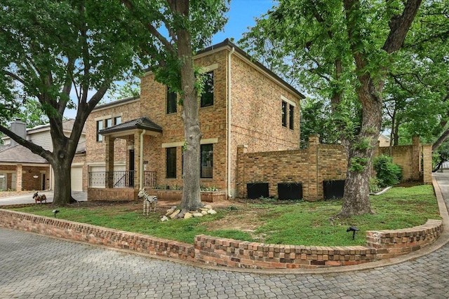 view of front of property with brick siding and fence