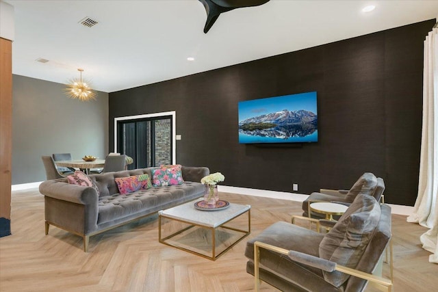 living room with baseboards, recessed lighting, an accent wall, and visible vents