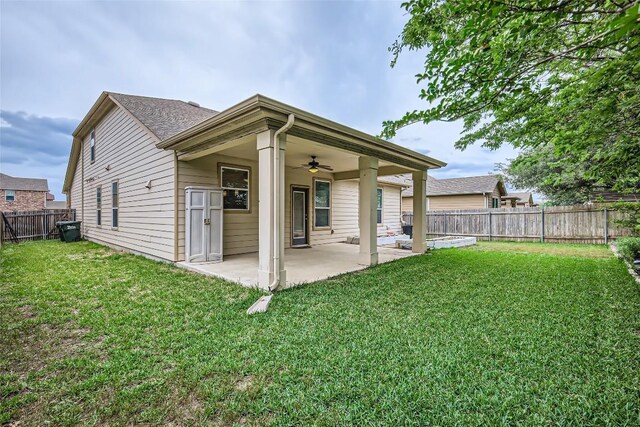 back of property featuring a fenced backyard, a patio, ceiling fan, and a yard