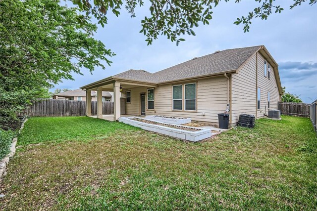 rear view of property with a fenced backyard, a patio, ceiling fan, and a lawn