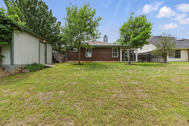 7421 Ponoma Trl, Austin, TX 78749 - rear view of property with a lawn, a chimney, fence, and brick siding