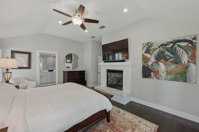 7421 Ponoma Trl, Austin, TX 78749 - bedroom featuring a brick fireplace, baseboards, wood finished floors, lofted ceiling, and visible vents