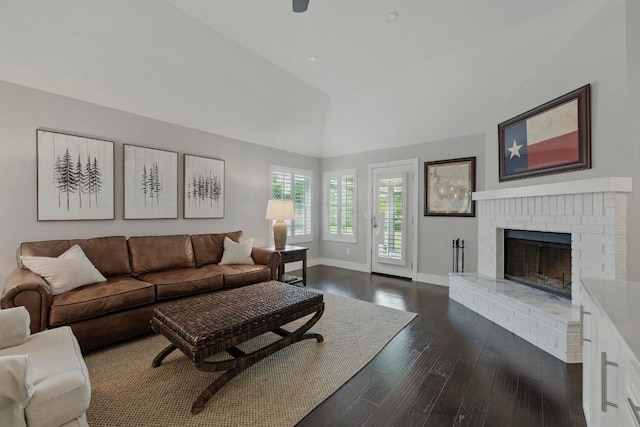 7421 Ponoma Trl, Austin, TX 78749 - living room with a fireplace, baseboards, vaulted ceiling, and dark wood-type flooring