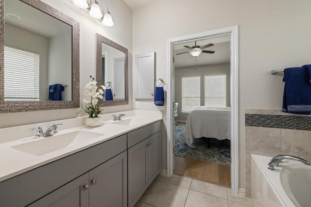 full bathroom with a garden tub, a sink, ceiling fan, and ensuite bath