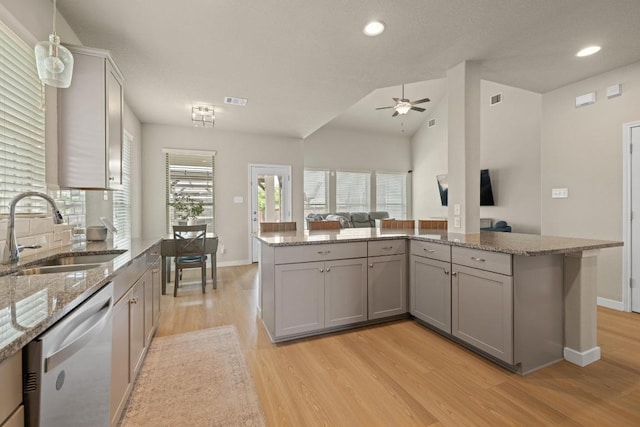 kitchen featuring ceiling fan, a sink, gray cabinets, light wood-style flooring, and stainless steel dishwasher