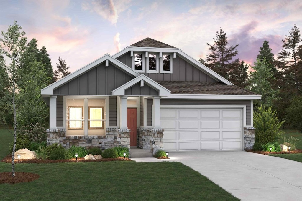 craftsman house featuring board and batten siding, a lawn, concrete driveway, and stone siding