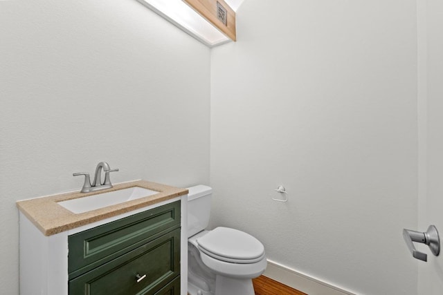 3800 Laurel Ledge Ln, Austin, TX 78731 - bathroom featuring toilet, vanity, wood finished floors, and baseboards