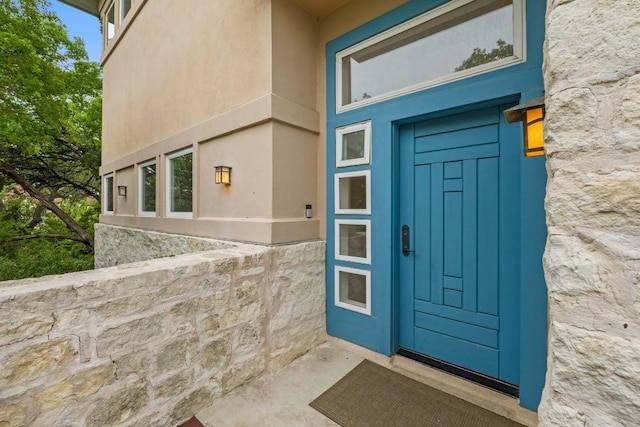3800 Laurel Ledge Ln, Austin, TX 78731 - doorway to property featuring stucco siding and stone siding