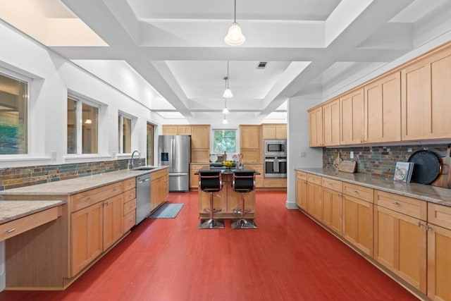 3800 Laurel Ledge Ln, Austin, TX 78731 - kitchen with stainless steel appliances, dark wood-style floors, a tray ceiling, light brown cabinets, and light stone counters