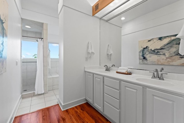 3800 Laurel Ledge Ln, Austin, TX 78731 - full bathroom featuring baseboards, a stall shower, wood finished floors, double vanity, and recessed lighting